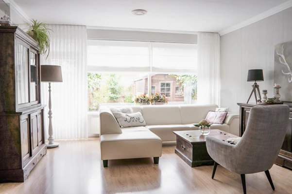 Balancing Light and Air in Your Living Room for Feng Shui A balanced and serene living room with ample natural light, a comfortable sofa, and clean airflow, demonstrating good Feng Shui principles for a harmonious home.