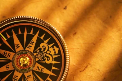 Close-up of a golden traditional Feng Shui Luopan compass used for determining Bagua map orientation.