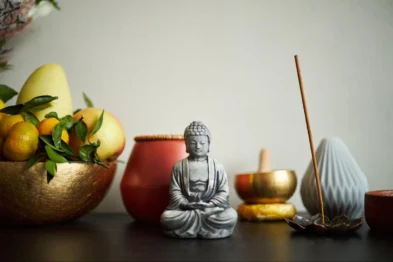 Buddha statue with incense and fruit symbolizing balance and harmony in feng shui home design