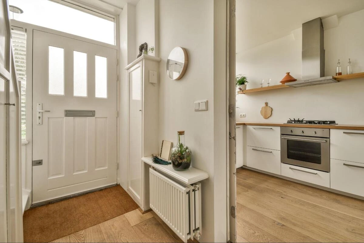 A kitchen with a gas stove, oven and timber worktop